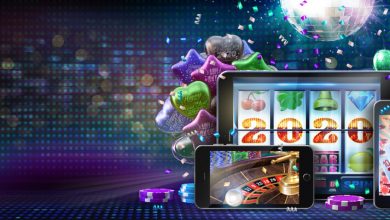 Online casino gambling concept image for celebrating 2020 New Year. Slot, poker, roulette games on mobile devices and mirror ball, balloons, confetti in the background. 3D illustration with copy space