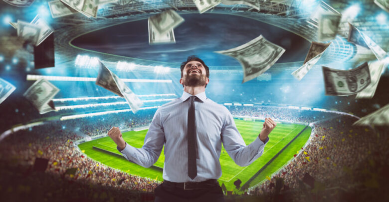 Man who rejoices at the stadium for winning a rich soccer bet