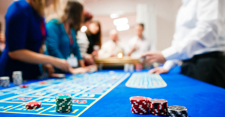 green roulette table with colored chips ready to play