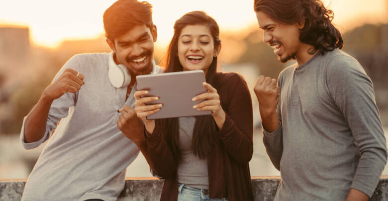 Excited of friends watching sports from tablet