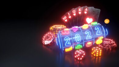 2022 Year Online Casino Gambling Concept. Royal Flash Poker Cards, Slot Machine, Dices And Roulette Wheel With Neon Lights - 3D Illustration